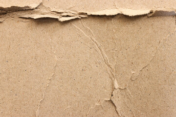 cardboard sheet textured background with crumples and torn, brown color