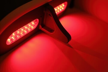 Red led rear brake light with defogger vent close-up on modern vehicle