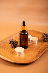 Amber Dropper Bottles on Wooden Tray with Candles and Linen for Spa and Skincare Product Display