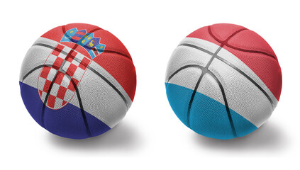 basketball balls with the national flags of luxembourg and croatia on the white background.
