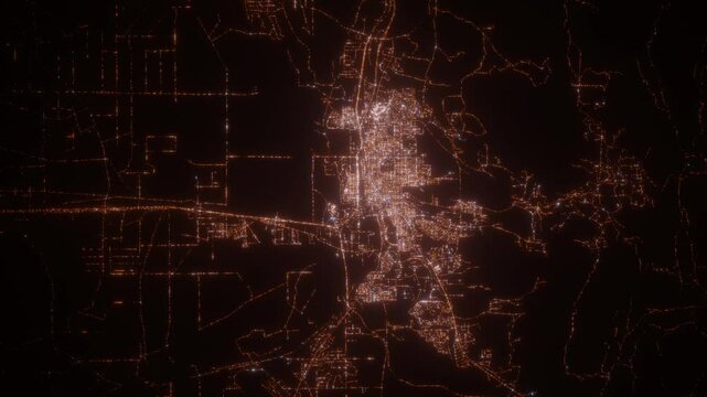 Casper (Wyoming, USA) top view at night. Aerial view on modern city with lights. Camera is flying above the city, moving backward. Vertical video. The north is on the left side