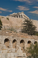 View of the  Acropolis surrounded by ancient architecture in Athens, Greece during a clear day