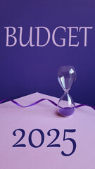 Planning Budget 2025 new year symbol. Budget 2025 text with hourglass on pink table, purple...