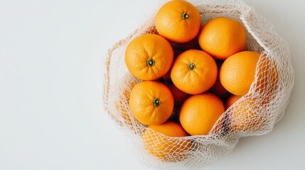 Fresh Oranges in Cotton Net Bag on White Background - Simple and Healthy Concept