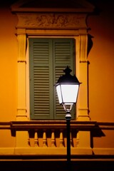 Street lamp in the city at night in front of a window