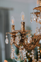 Elegant chandelier with glass crystals illuminating a cozy room setting