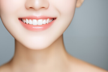 Obraz premium close-up of smiling woman with perfect white teeth on neutral background