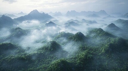 Obraz premium A breathtaking aerial view of mist-covered mountains, showcasing lush greenery and a serene atmosphere.