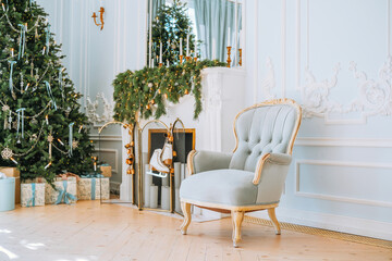 Elegant holiday living room with a chic chair and a beautifully decorated tree