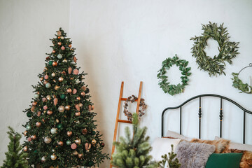 Festively decorated room with a Christmas tree and garlands in winter