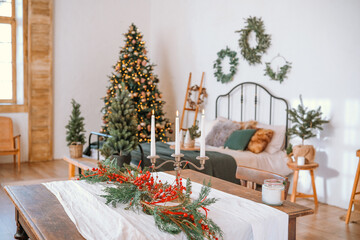 Cozy holiday living room decorated with a Christmas tree and festive greenery