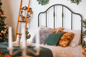 Cozy holiday bedroom setup with festive decorations and warm textures
