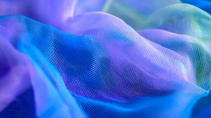 A close-up of soft flowing blue mesh fabric with glowing details and vibrant tones.