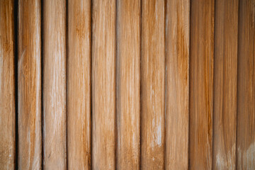 Natural wooden wall featuring vertical planks in warm tones at a cozy interior