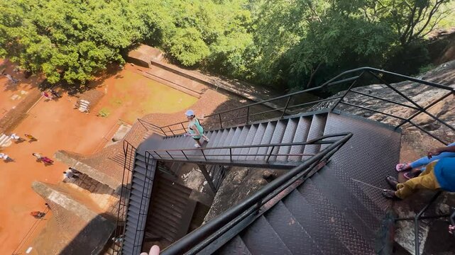 Girl coming down the Sigiriya Mountain stairs pov - Sri Lanka