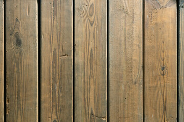 The old wooden plank is weathered, cracked, and rough.