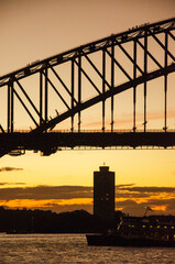 Picturesque view on Sydney Harbor Bridge at sunset. The bridge was opened in 1932 and it is the tallest steel arch bridge in the world.