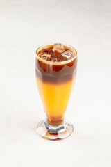Glass of iced bumble coffee drink with orange juice