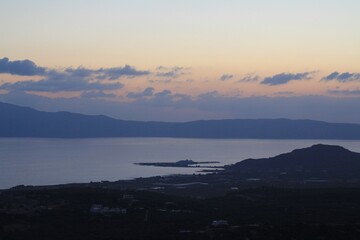 The Serene Twilight Casting Its Mystical Glow Over the Calm Sea and Rolling Hills