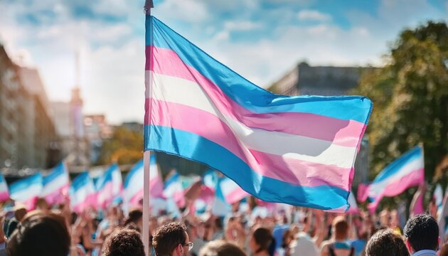 Close-Up of Transgender Pride Flag Waving Over Supportive Crowd During LGBTQ+ Equality March, Symbolizing Acceptance, Gender Identity, and Community Solidarity in a Vibrant Urban Setting