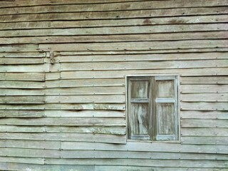 The brown wood texture wall and  window of the old style house.