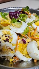 The colorful salad with cucumber, lettuce, mango, avocado, and sesame seeds is a perfect blend of freshness and flavor. The crunch of the cucumber and the lightness of the lettuce balance perfectly wi