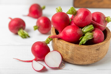 Fresh radish on textured wooden background. Organic natural garden radish slices. clipping root crop. Vegetables. Vegan. Diet products. Healthy food. Place for text. Copy space.