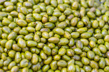 Green olives at the local market Selective focus. full-screen background close-up