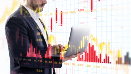 Businessman in a suit working on a laptop, overlayed with stock market charts. Financial data concept on a blurred background. 3D Rendering