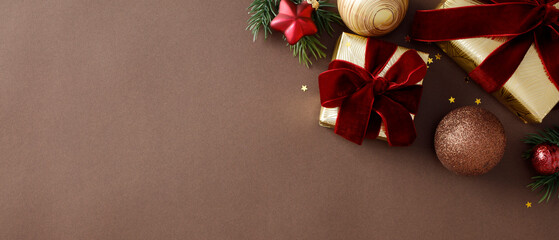 Luxurious holiday decor with gold-wrapped gifts, red velvet bows, and glitter brown ornaments. Xmas banner template.