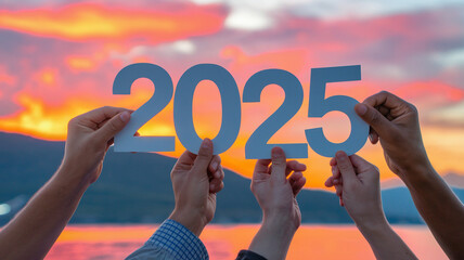 Multi-ethnic hands holding "2025" sign text against a beautiful sunset, symbolizing unity and hope for the new year. Vibrant and inclusive, ideal for New Year's celebrations.

