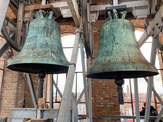 Two old big bells in church tower of Chioggia, Italy