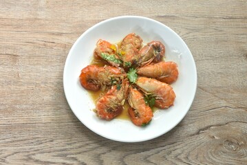 deep fried salty river shrimp with chop garlic and pepper in fish sauce arranging on plate 