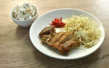 slice grilled chicken with Teriyaki Japanese sauce and chop cabbage on plate eat couple rice mixed sesame in cup