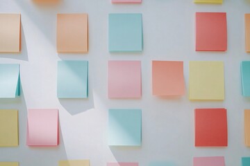 Colorful sticky notes scattered on a white surface create a vibrant and playful workspace atmosphere
