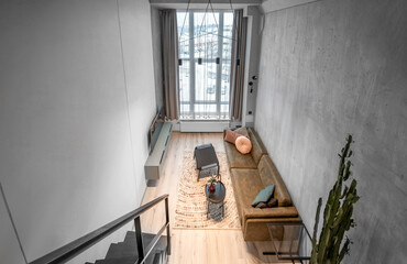 Luxury Loft Style Studio Apartment Stylish Modern Living Room Area, Cozy Bedroom. Minimalistic Modern Interior Without People. Big Sofa, Table, TV, Window. Hardwood Floor and carpet.