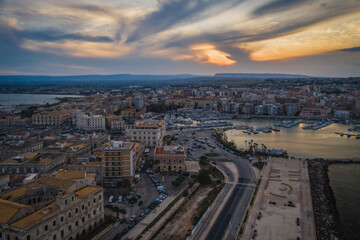 Siracusa, Ortigia Island from the air at sunset, Sicily, Italy. Isola di Ortigia, coast of Ortigia island at city of Syracuse, Sicily, Italy. Aerial view. June 2023