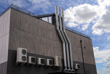 Stainless steel chimney smokestack pipe on the facade