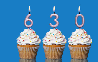 Birthday Cupcakes With Candles Lit Forming The Number 630