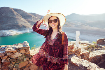 Beautiful latin woman outdoors in the Huasco valley with a damn in the background