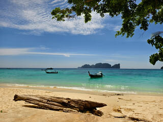 A serene and beautiful tropical beach paradise featuring traditional boats
