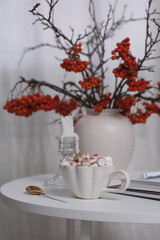 A Cozy Coffee Setup Featuring Beautiful Autumn Decor, Notebooks, and a Relaxing Atmosphere