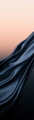 Fototapeta premium A smooth, flowing piece of black fabric against a soft gradient background, evoking elegance and sophistication.