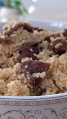 Traditional Bangladeshi biriyani served in a bowl with fragrant rice, tender marinated meat, and aromatic spices. A popular South Asian dish, rich in color and full of authentic flavors