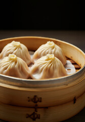 Steamed Xiao Long Bao served in a wooden bowl