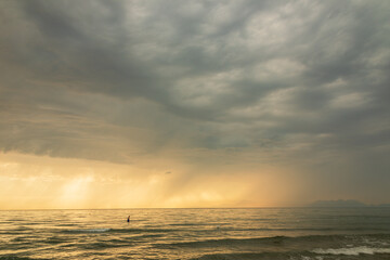 Obraz premium Stormy sea. Sunset with clouds and a light of colors. Water wind and sun. Seascape