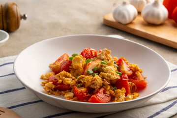 Stir fried egg with tomato,Scrambled eggs with tomatoes on white plate