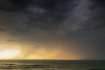 Stormy sea. Sunset with clouds and a light of colors. Water wind and sun. Seascape