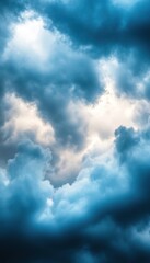 Obraz premium A swirling display of dark and light clouds set against a dramatic sky, creating a moody and atmospheric effect.