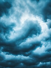 A moody sky filled with swirling dark clouds, creating a dramatic and atmospheric scene.